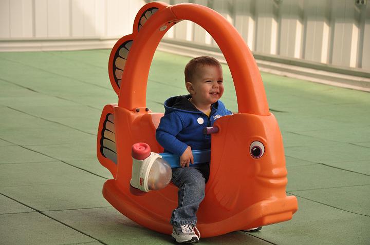 Jackson riding a fish and holding the popper